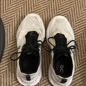 On Running Cream and Black Athletic Shoes